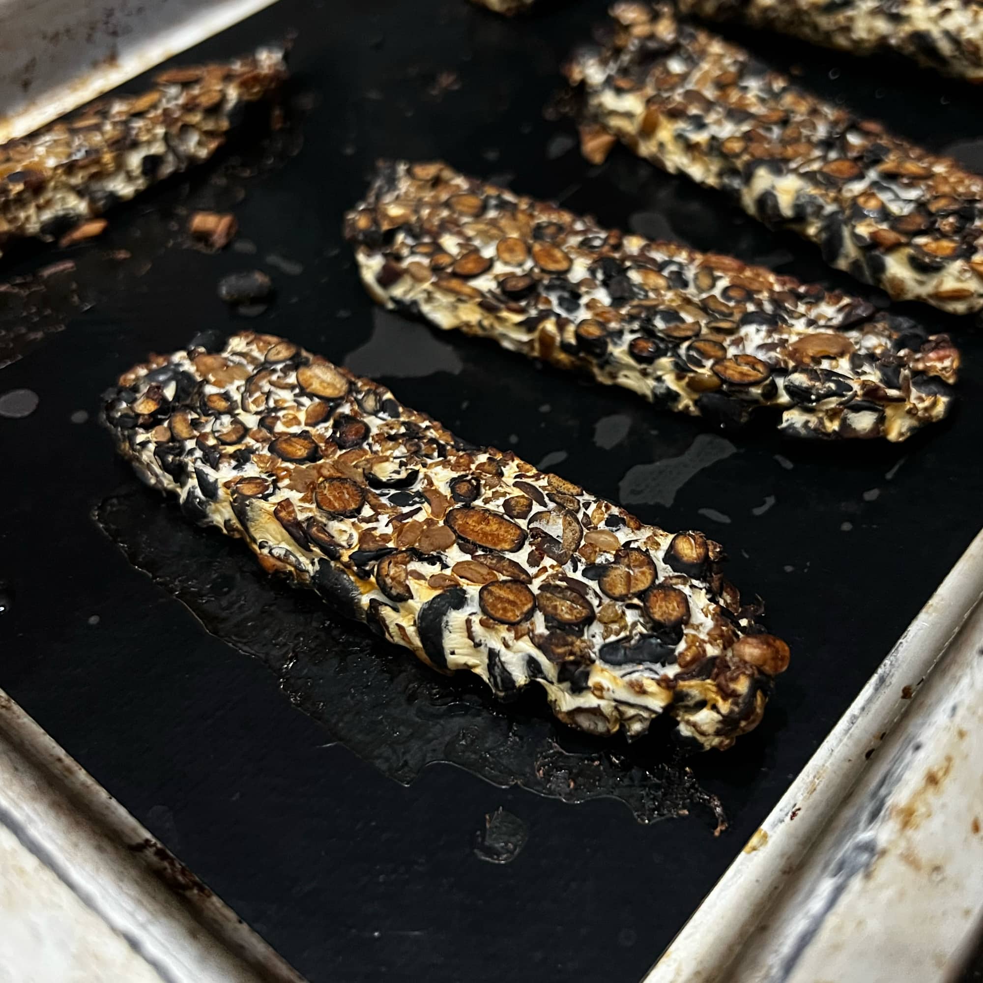 a baking sheet with sliced smoky marinated tempeh on it.