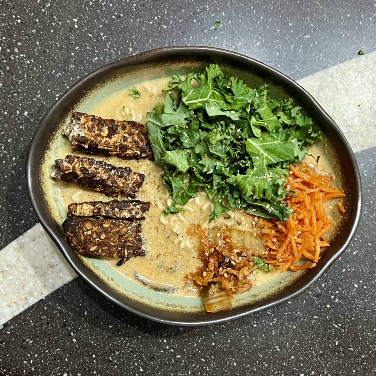 a bowl of creamy vegan ramen with asian-inspired marinated tempeh.