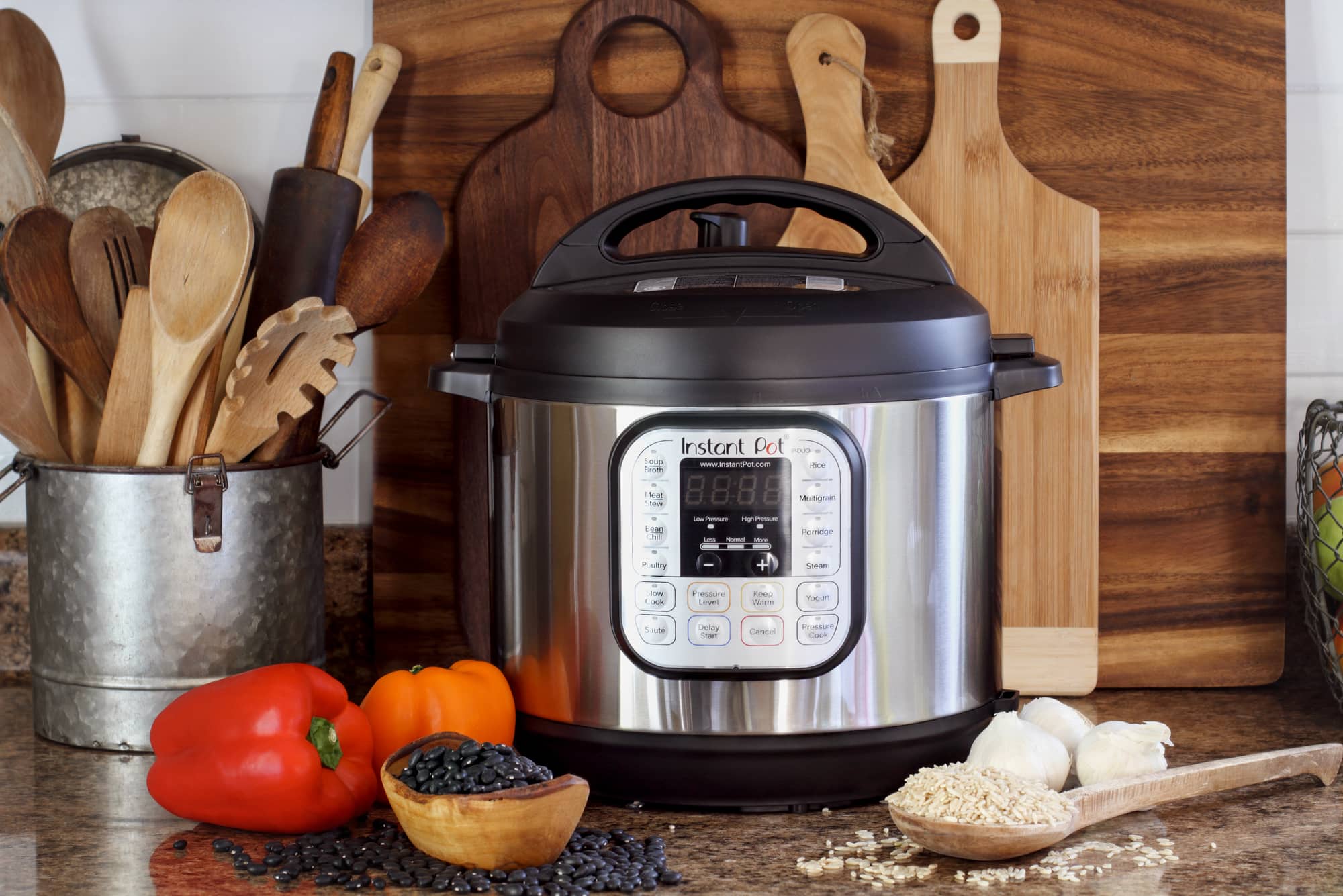 instant pot with rice and beans and cutting boards in background.