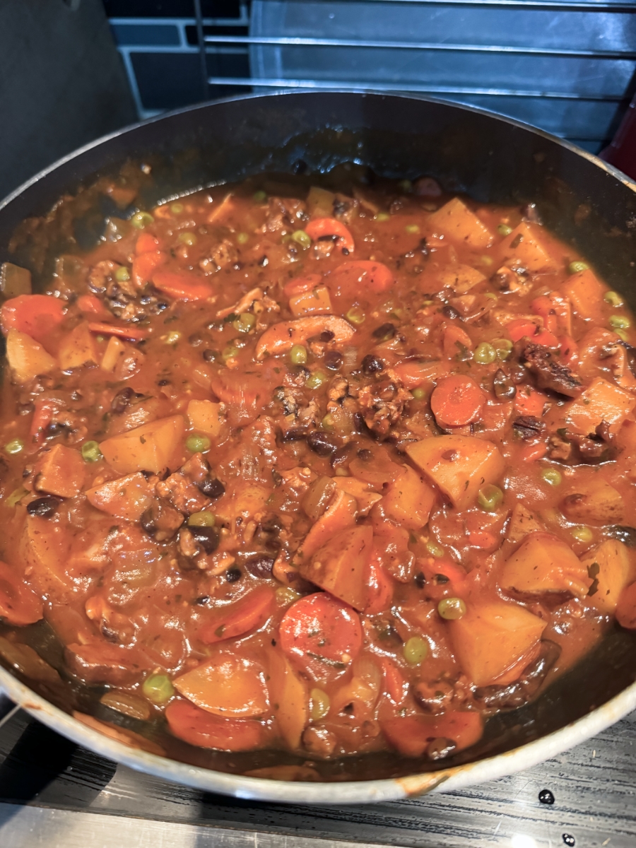 hearty tempeh stew in a pot on the burner finished.