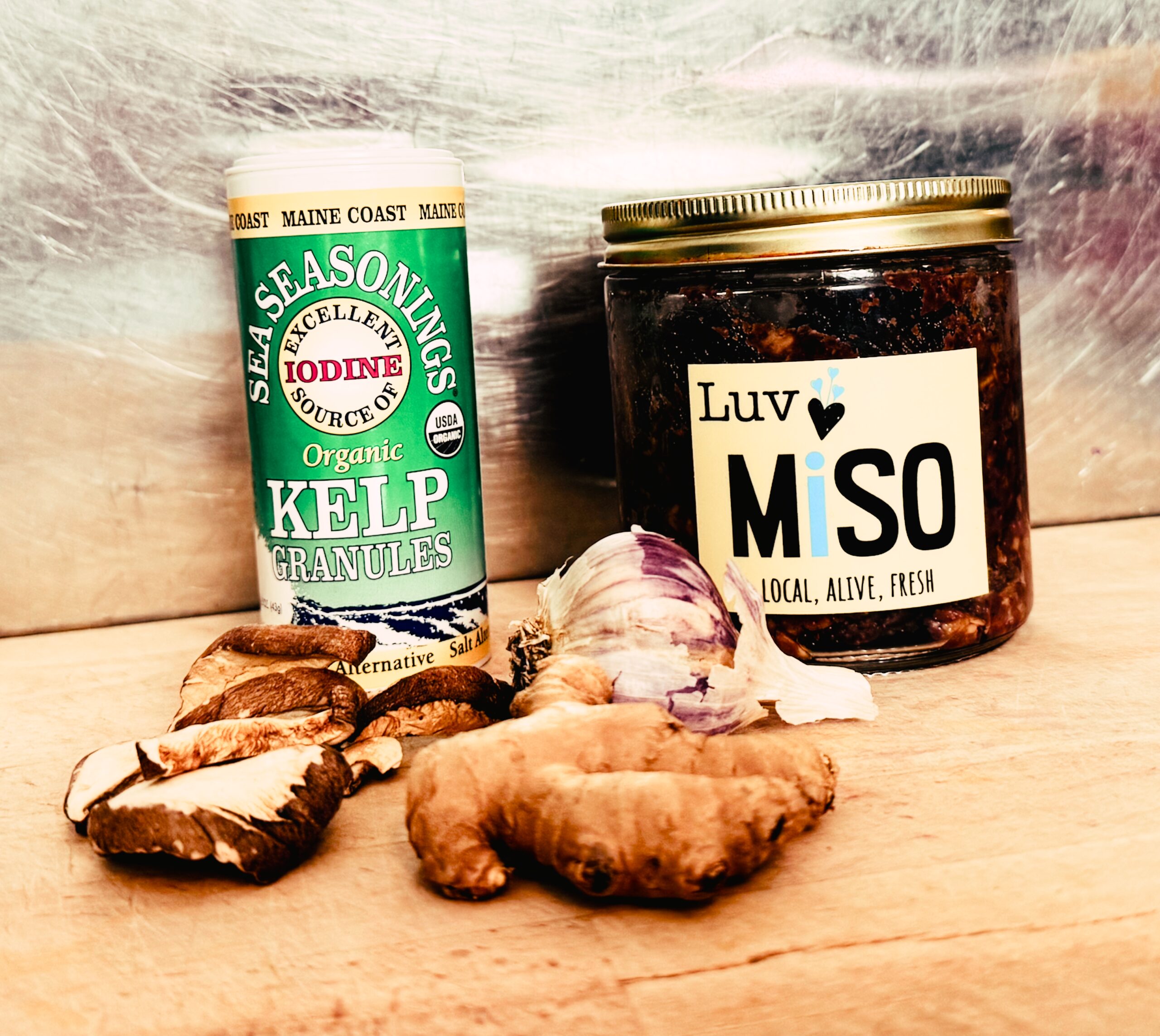 ingredients for miso sipping broth: kelp powder, garlic, ginger, shiitake mushrooms, and miso.
